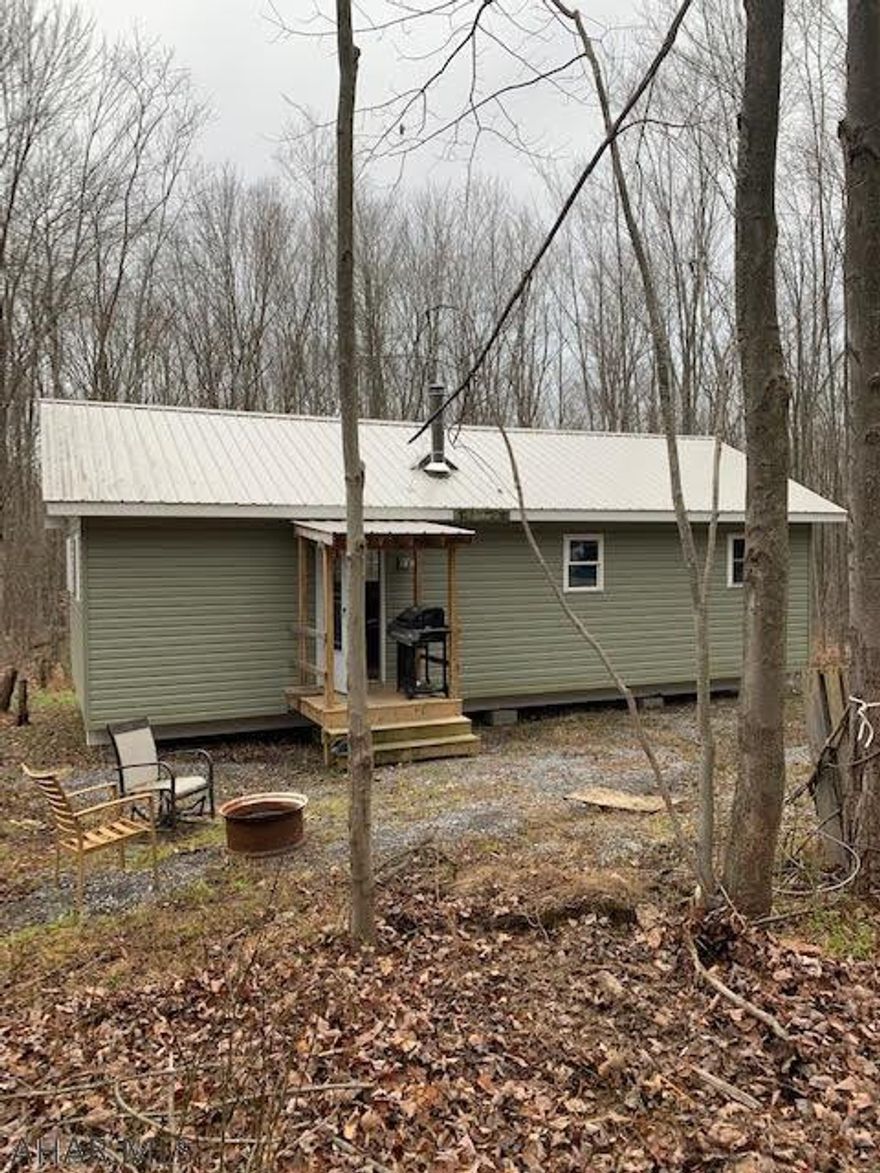 Recreational cabin on 9.8 wooded acres bordering large PA State Game Lands. Built in 2017 as a cabin and not to be used as a residence. The cabin contains a  living room, kitchen, dining room as one large room with vaulted ceiling. Large bedroom and shower with wall mounted water heater. Some finish needed. Generator provides the power to run the cabin off grid. Approved outhouse on site and site is approved for on lot sewage. Great getaway location approx 15 minutes from Altoona. Great hunting on site and the miles game lands.