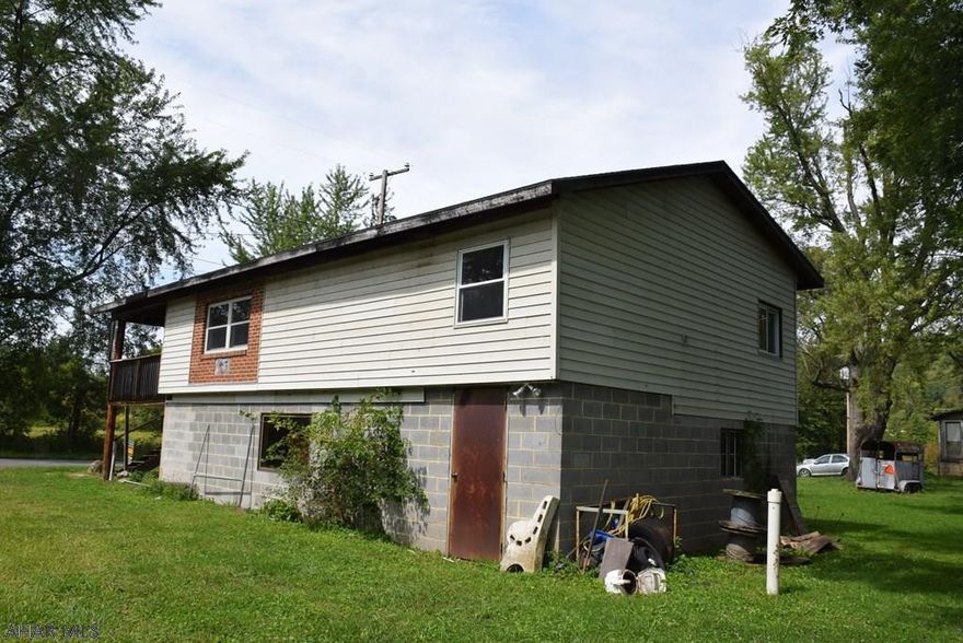 Three properties in one sale.  Two homes and a one acre vacant lot.  Income producing potential for the right person.  LIve in one, and rent the other one or use both for rentals.  Beautiful new kitchen and flooring in one of the houses.  Properties are being offered in "as is" condition.   Handy man special at the right price!