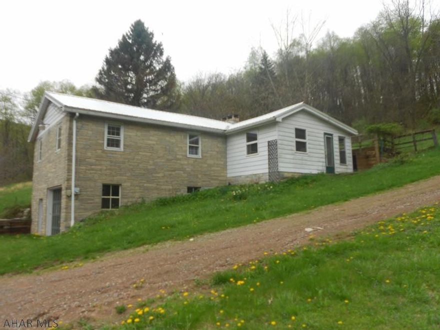 This is all about the acreage. 26.6 acres that flattens out on top. Small cabin in process of being built close to the top. Great hunting. House needs some TLC. Sits across the road from Yellow Creek trout stream. Fishing, hunting very close to state game lands.