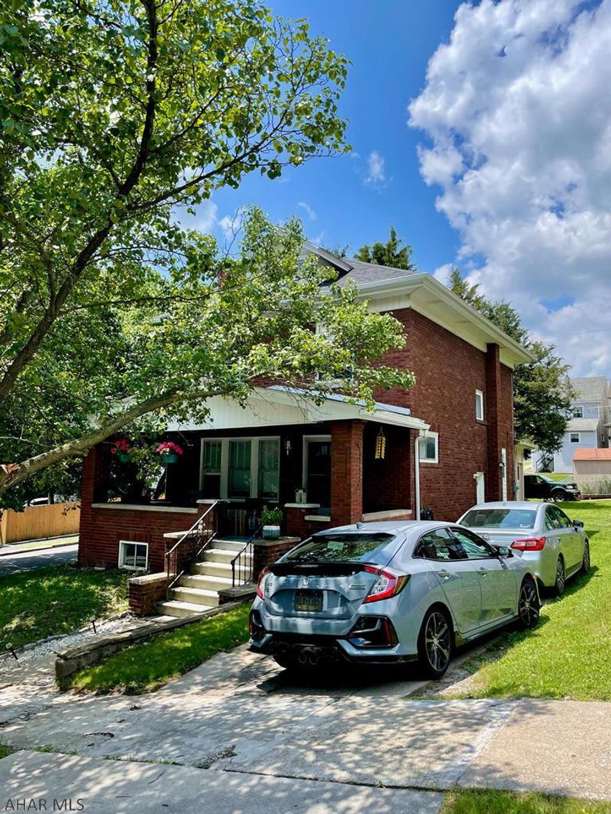 This spacious brick home on a double lot was all updated in 2016. The gorgeous staircase and original fireplace give the living room so much charm. Formal dining room and cute modern kitchen has stainless appliances that stay with the home. Luxury vinyl plank floors throughout. All 3 bedrooms are generously sized, the bathroom is oversized too and has it's own linen closet. attic walkup gives tons of extra storage. Basement has been finished into a fabulous rec room with a really cool bar. Outside you will find off street parking on a corner lot, and an adorable porch to BBQ on.  The trees in the back yard keep it nice and private and there is plenty of room to add more parking or a garage in back. OH- and the Seller Say's BRING ME AN OFFER TODAY!!