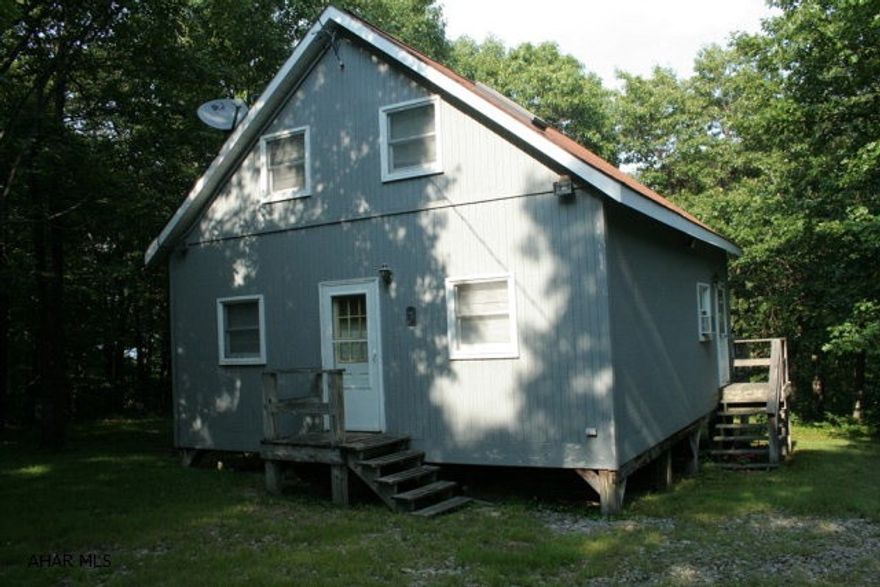 Cozy cabin set in the privacy of the gated community of Buck Run. Spacious home is on 3 acres with woods surrounding the property. Cabin has full size kitchen, bathroom and bedrooms and can sleep 8. Great for weekend getaways or full time living. Full length deck along back of cabin is perfect for entertaining or just a relaxing evening enjoying your surroundings. A must see property!