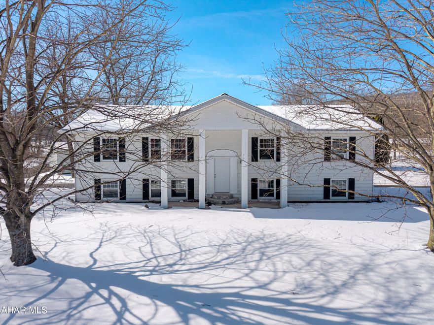 Welcome to 8063 Main Road, Bedford, PA! This charming bi-level home has it all—great location, fantastic amenities, and plenty of character. Featuring 3 spacious bedrooms and 2 full baths, a large living room, and an open kitchen with an eat-in area perfect for gatherings. Enjoy granite countertops, a large island, ample storage, and a pantry. Step out to your private balcony for those summer vibes! There's also a bonus room off the kitchen that can be a formal dining room, office, or playroom. The large, finished basement boasts a cozy fireplace, plus a laundry and utility mudroom. A 2-car garage and private driveway add convenience, while the flat yard is great for outdoor fun. Close to town for everyday needs yet offering peaceful country living, with easy access to the Pennsylvania Turnpike and I-99. A must-see!