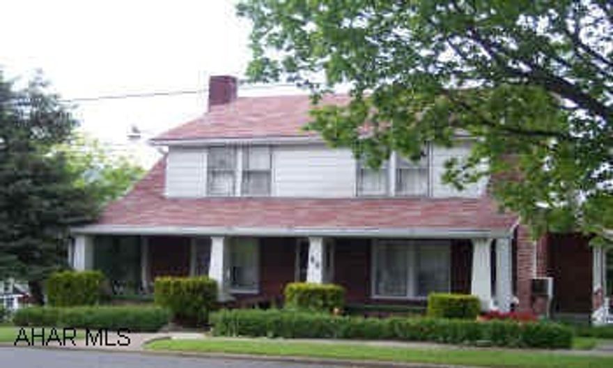 two story brick house with with three car detached garage and patio with BBQ.