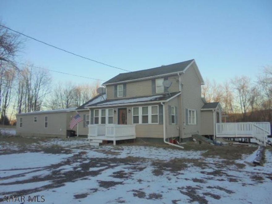 Blacklick Township- Secluded describes this 2 story vinyl sided 3-5 BR home on almost 1 acre. . Family room with wood burner. Oil HW heat. Sit and watch the wildlife from the large rear deck. There is an attached 3 BR, 2 bath double wide that could be separate living quarters. Ideal for in-law suite. built in 2017 with electric heat pump