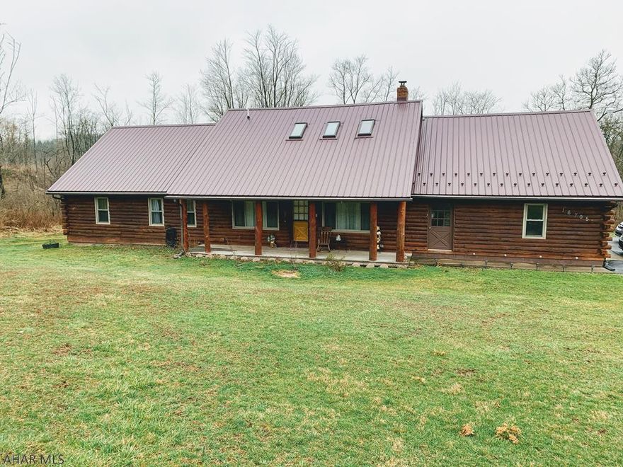 Log home with a possible mother in law suite - This large 4BD 3BA home on 2.4 acres offers large front porch, hardwood floors, large living room w/ pellet stove, dining room, galley kitchen w new backsplash, stainless steel appliances, pantry, 1st floor laundry area, whirlpool tub. 2 nd floor offers full kitchen open to dining area and family room w skylights, 2 bedrooms and full bath. Deck, 2nd story balcony, fenced in yard area, large 2 car garage, 2 sheds black top driveway.