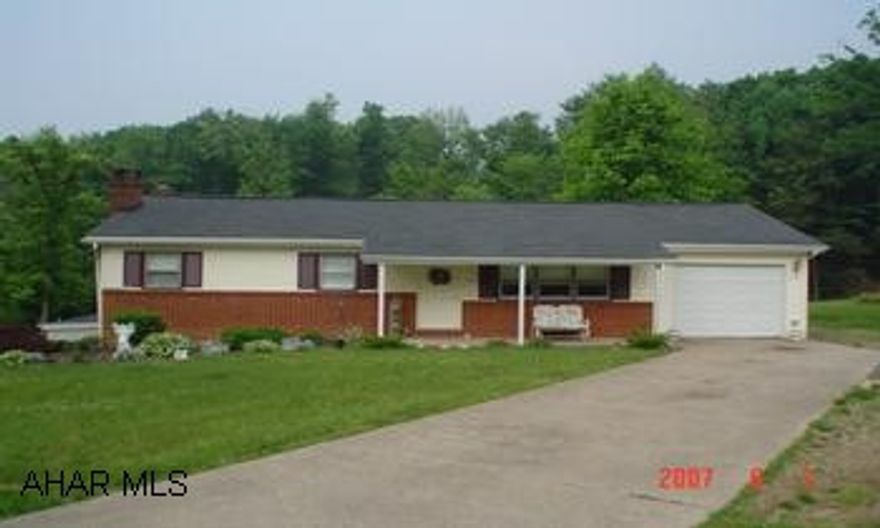 Tan vinyl & brick rancher with 1 car attached garage.  Cherry kitchen, 3 heat sources, central air.
