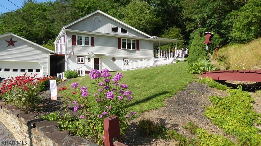 Sitting in the foot hills of the Allegheny mountains is this charming home.  Each area of the home has been well maintained and each space well utilized.  The manicured lawn and flower gardens can be seen from all areas of the property.  Sit back and relax on the back porch, watch the birds at the many bird houses, work in the wood shop, or maybe just take a walk up the hill to enjoy the view.  This property contains 5+ acers for hiking, hunting, or gardening.  It is conveniently located by the "H & BT"  Rails to Trails, the Juniata River, Raystown Lake, and so much more.