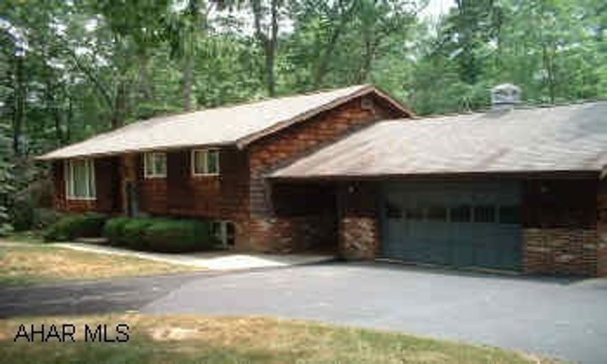 Great setting for this cedar sided home. Beautiful stone fireplace. Private back.