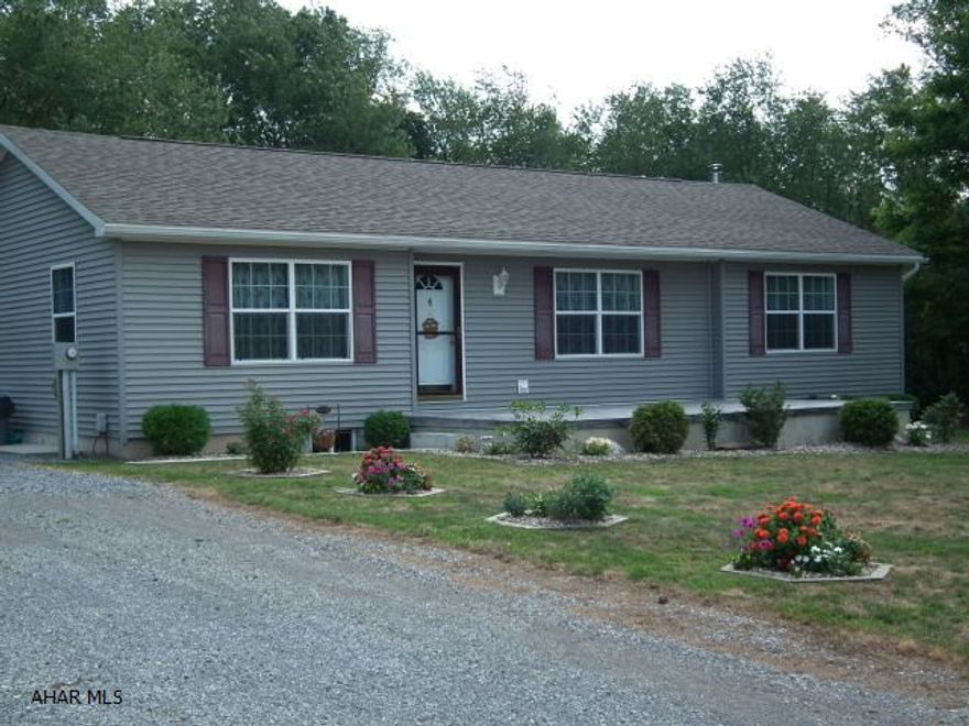 This one story Home offers wooded surroundings on 1+ acre.  Built in 2004 home is like new.  Private Patio in back & newly poured front patio.  Home offers 3 Bedroom, roomy living room - kitchen with eating area & sliding glass doors leading to patio.  See pictures.  Shared maintenance is written into the deed.