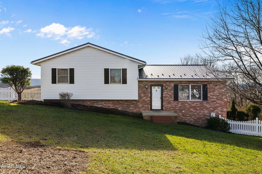 Discover modern comfort in this charming 3-bedroom, 2.5 bath home, perfectly situated in a desirable neighborhood just moments from town conveniences. The multi-level layout offers distinct living spaces, while the expansive deck provides a private retreat and truly stunning, picturesque views. Main living area is inviting with light-filled open floor plan seamlessly connecting the living, dining, and kitchen areas, ideal for both entertaining and everyday life. The multilevel floor plan offers privacy as it separates the spacious bedrooms from the main living spaces. The lower level is perfect for entertaining with doors that continue to additional outdoor entertaining areas.  Adding a unique spin is the neighboring property that is also for sale.  Purchase one or both.  Call today to see which one is right for you!