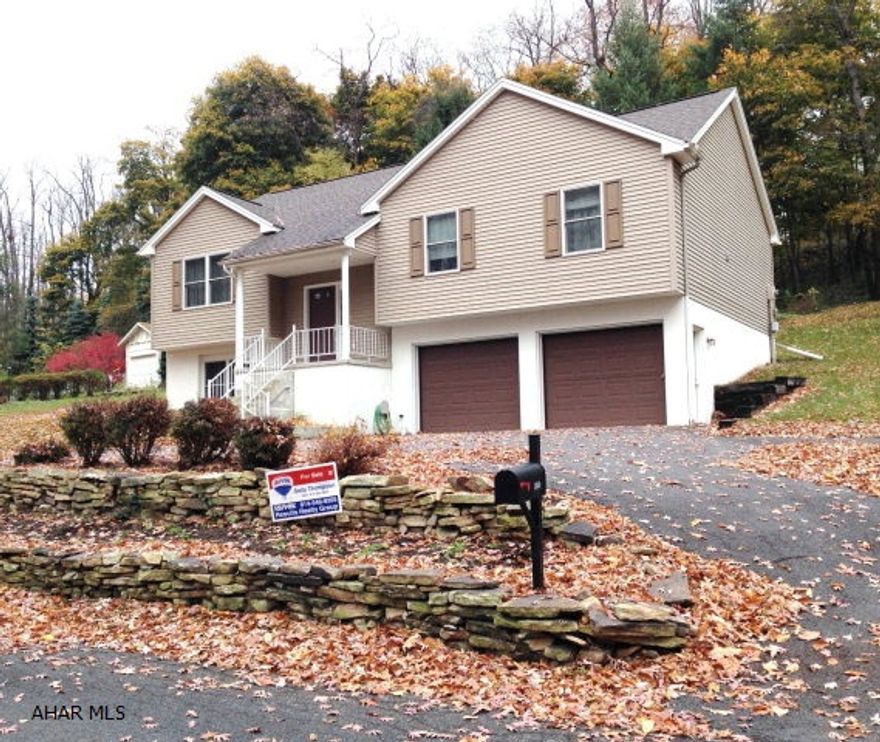 Bi-level located in a quiet wooded setting.  3BR, 2 1/2 Bath with hickory cabinets in kitchen.  Two car garage plus 1 car with greenhouse attached.  Lots of storage.  Central air, nice composite decking, plus patio with stone pavers.