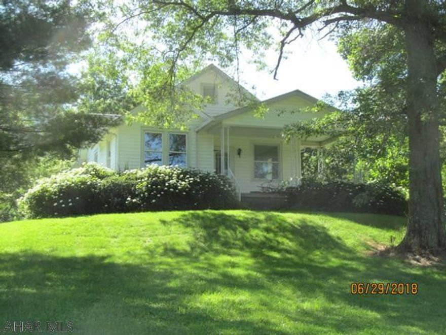 Surrounded by fields & woods, this 1938 cottage ranch invites you to sit on the front porch and visit awhile or just enjoy the view. Original woodwork & hardwood floors add to the charm of this 3BR, 1BA home w/ oversized 1 car garage & sm. wood/block barn. Situated on a grassy knoll, this peaceful 2.8 acre setting has just the right amount of privacy to make coming home a joy.