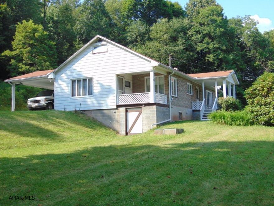 Well built 3 possibly 5 bedroom, 2.5 bath home adjacent to State Gamelands. Hardwood throughout under freshly cleaned carpets.  Over 5 acres with two large garages and a carport attached to the home.  Extremely clean home!