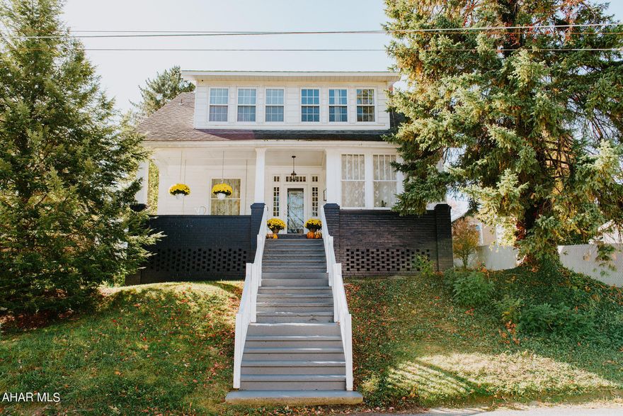 This 3-4 bedroom, 2 bath home is move in ready. Enjoy the back yard, or sitting on the covered front porch and in front of  the fire place on cold winter nights. There is so much uniqueness to this home, it also has a '3 season closed front porch', a TV room/office, a bonus room on 1st level that could be a bedroom or family room, 1st floor laundry and full bath. Beautiful light fixtures welcome dusk! Wood Floors under most carpets. It's close to Crichton McCormick Park, town, Drive-in theatre & Blue Knob Resort. This home is talked about in the book 'Digging For Treasure' by Jean Crichton. It was a Summer home to the Crichton family.