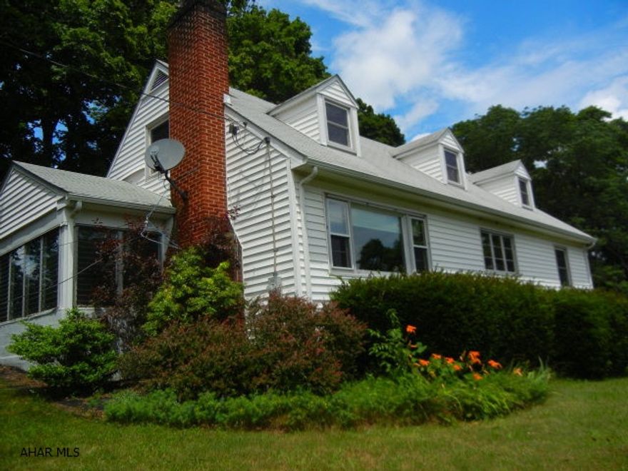 This 3 bed. 2 bath Cape Cod is situated on l.37A with lots of privacy yet minutes from town.  First floor bedrooms and bath. Second floor has new replacement windows. Central air in first floor. Large bonus rm on second floor.  Enclosed side porch. Nice hardwood floors throughout.  Epoxy garage floor. Barn can be used for additional  storage or hobbies.