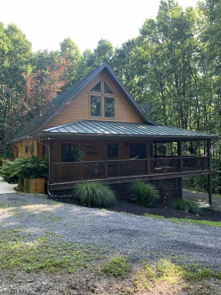 You'll fall in love with this well-built 2005 two bedroom plus loft, 3 bath home sitting perfectly on 25+ wooded acres.  Private setting surrounded by nature!  Open floor plan with vaulted and beamed ceilings, stone fireplace in the Great Room, large kitchen area with granite counters, solid wood cabinetry, travertine floor! First floor master bedroom with ensuite bath!  Wrap and covered decks, ground level entrances on each floor!  This home is sure to impress!  Close to Shawnee State Park, game lands, MD border, Bedford Springs Resort.