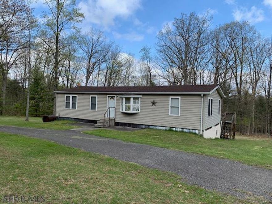 Country living on 4 acres!  Furnished and ready for new owners with some TLC.  Full basement.  Cathedral ceilings and walls are drywall. Flooring is Laminate and kitchen area needs to be completed flooring is provided.  AS-IS, WHERE-IS.