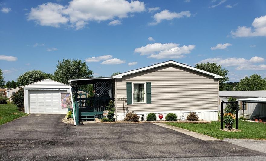Beautiful 3-bedroom 2-bath Redman mobile home in Spring Drive, titled in 2001, new Kitchen counters, garage w/auto opener, 8x12 shed, side deck, 2019 shingle roof, nice covered porch, private patio, oil forced air heat + new mini-split heat/ac unit Sept 2020.  $290/mo lease includes garbage & road maintenance. J-528