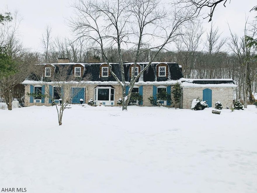 Logan township. This large 2 story 4 bd 2.5 ba home w approximately 3600sq. ft. sits on private setting of approximately 2 acres, and offers large rooms throughout. EI kitchen w cherry cabinets and granite countertops, large living room and family room w dual sided fireplace, formal dining room w hw floors, master bedroom w master bath w/in closet, a large additional living area that could be a possible  2 story in law suite that has its own entrance and balcony that overlooks the back fenced in yard. Interior of home has been freshly painted and offers newer carpet. Newer roof and furnace. Large 3 season sunroom w skylights that opens to a large deck that could be great for entertaining. Lots of storage. Large unfinished waterproofed basement. C/A. Shed.