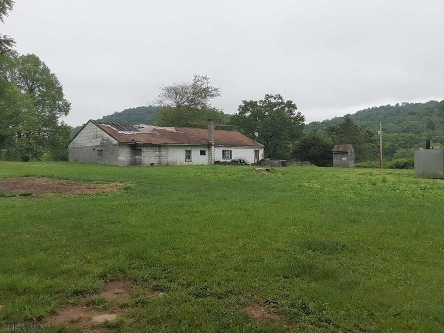 THINK OUTSIDE THE BOX !!!  This property has 1.28ac. with well and septic.  You can rehab the house and 1 car garage. OR  Add a dblwide, modular, or stickbuilt onto the property.  The original block house could easily be converted into a large garage, workshop, and man cave.  Use part of the building with the patio for outdoor entertaining.  Lots of possibilities with this property. You are only limited by your imagination!