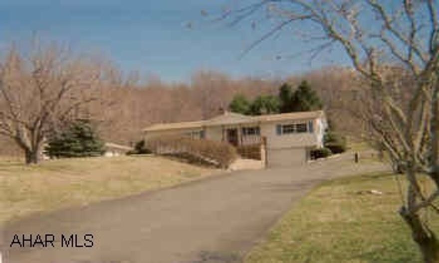 Ranch Home with two-acres, lovely hardwood floors. Fireplace in living room. Lovely view, hardwood floors, central air, corian sink in kitchen , covered rear patio.