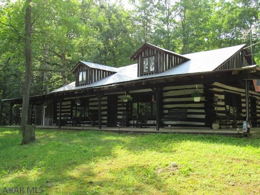 Majestic views of a 2.8 acre pond with island, dock & bridge to a peninsula is outside your front door on this 39 acre wooded property with its large log cottage that can be used for a vacation get-away, hunting lodge, retreat or year round living!  This secluded property with its uncut timber adjoins State Game Lands 73 and is within close proximity to Lake Raystown. The 64x45 out building can store your RV, Boats, all-terrain vehicles & much more. The 16'4x12'6 Outdoor Furnace Building heats the home with oil, wood or coal. There is also a Gazebo with a well pump, & a finished Out House with modern amenities, see for yourself! The Log Cottage has a great room with log beams, a magnificent handset stone fireplace with fossil above the mantle. There is also a 40x10 enclosed 3 season porch