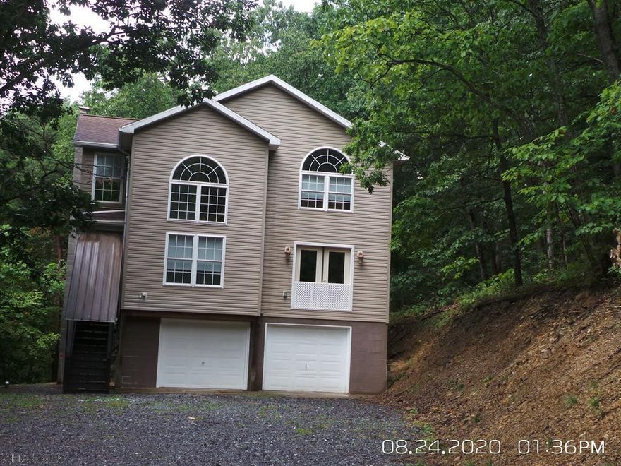 Only 1 mile to Shy Beaver boat launch!  Nestled in a wooded 1 acre lot, this 3 Bedroom, 3.5 Bath home is located in the Lakeview Estates area, but not in the development, so no deed restrictions!  The 2nd & 3rd floor has never been lived in.  The lower level is a 2 car garage that was finished and owner lived in it while building the upper 2 floors.  Doors are still there for garage use. New well pressure tank installed June 2021. Sewer is thru hopewell township