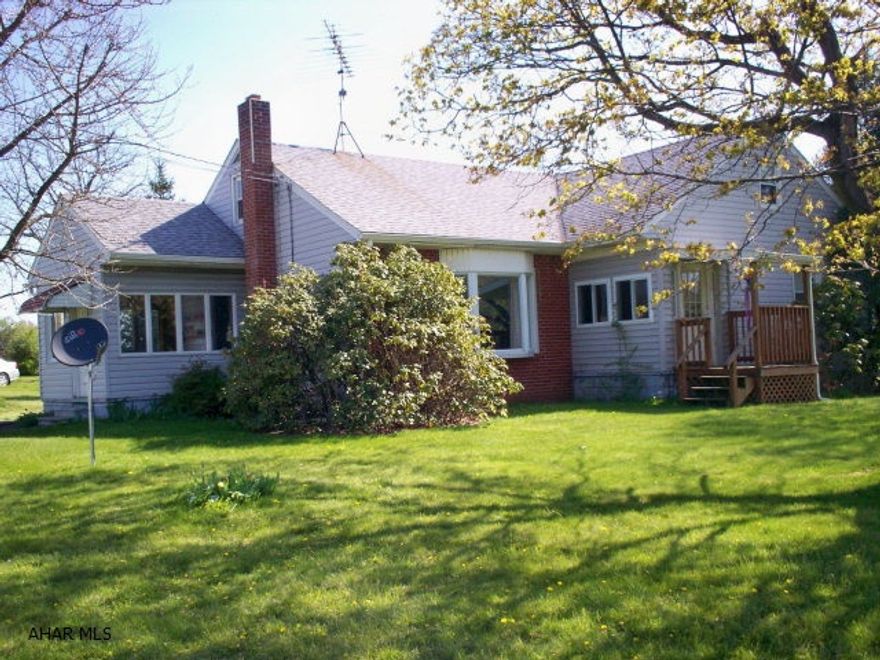 Vinyl sided, brick accent, replacement windows, large lot, two car detached garage with storage above. Public water & sewer.