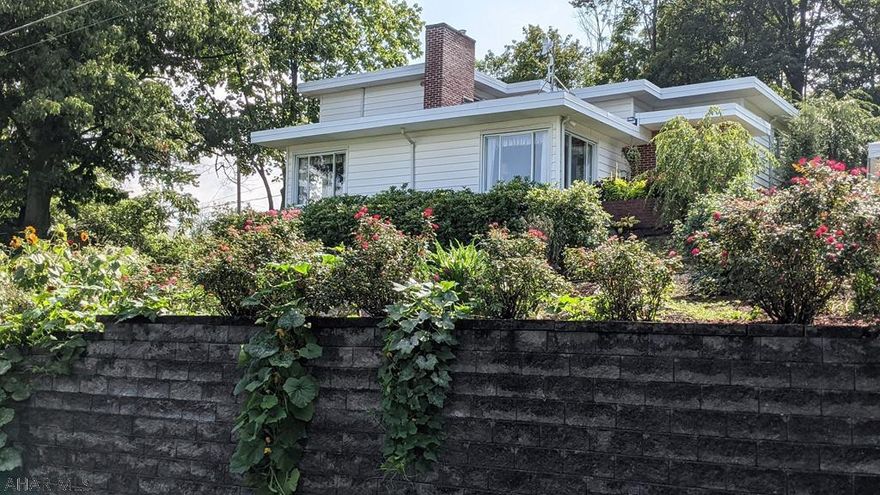 Intriguigingly Unique Home Reminiscent of "Falling Waters". This Multi-Level Contemporary Provides Comfortable Living in the Midst of Architectural Ingenuity. Each of the Five Levels Provides Its Own Space, Storage, Function, and Value. Real Hardwood Floors and Picture Windows with a Bird's Eye View of the City Bring Added Pleasure. Beautiful Landscape Envelopes the Home. Craftsman Hardscape Walls Blend with Lush Flowers and Vegetation. The Prolific Vegetable Garden features Sprawling Sweet Potatoes, Corn Stalks, and Tomatoes Hanging on the Vine. Seeing is Believing. Come and See.