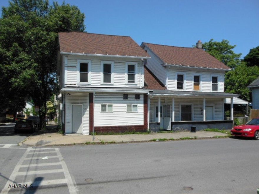 REDUCED!!  New Roof recently, some windows, furnace on one unit!  Formerly a bar/lounge on the corner,  with variance could be perfect for a store, beauty shop, office, has 2 half baths, old bar, rec room, stage, etc. 2nd floor apt. has 2 BR, & 1 Bt.  Side attached home has 2 bedroom, & 1 bath.  Separate utilities.  A side yard that leads to off-street parking for three. Property needs some work, but is worth the additional effort for the income it can produce. Please take a flashlight and be careful when going through now. Originally two houses attached in the middle. Great starter for someone enterprising.  Reasonable offer???