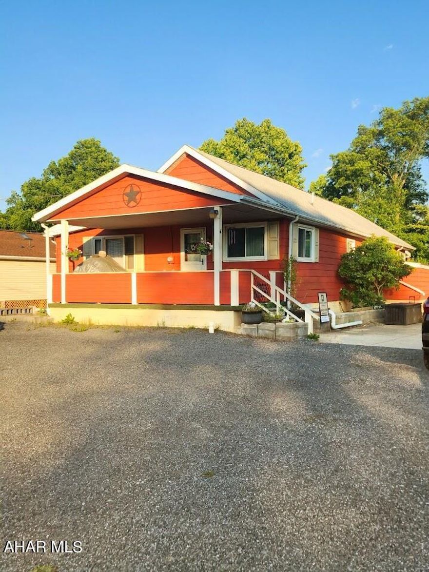 Charming 1-story frame cottage featuring 3 bedrooms and 1 bathroom, situated on two spacious lots. This property boasts a large living room, dining area, sunroom, and a versatile bonus room. Enjoy the outdoors with a generous wooden deck, patio, and fire pit, all overlooking Dunnings Creek at the back of the property. Ideal for a getaway home or year-round residence, with convenient access to nearby amenities, including a Dollar General store.  Selling as is.