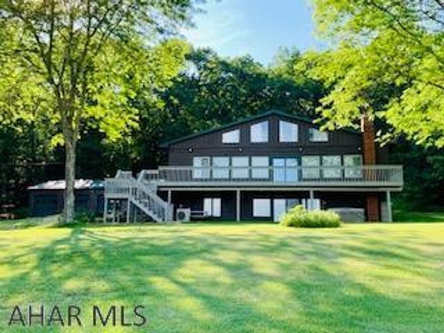 Outstanding picturesque views! This 5 BR 3 BA home has been beautifully updated w/open concept living. Entering the foyer brings you to fabulous wall of windows to enjoy the view. This home is filled w/ unique, high-end fixtures that gives you complete rustic retreat on 2.5 acres. Master bedroom/bath has duel updated vanities, walk-in tiled shower/tub combo. All closets are Cedar lined. Multiple heating options: electric radiant heat FL, heat pump, wood stove and electric fireplace. Brand new LVP flooring and carpeting throughout. Wraparound deck w/steps down to the yard and patio below. Finished downstairs, 3 BR 1 BA, laundry area. 2nd level offers a studio w/heat. Spacious 4 car detached garage w/epoxy FL, plenty of storage! This homes GLS is approx. 3500 sqft. High Speed Internet!