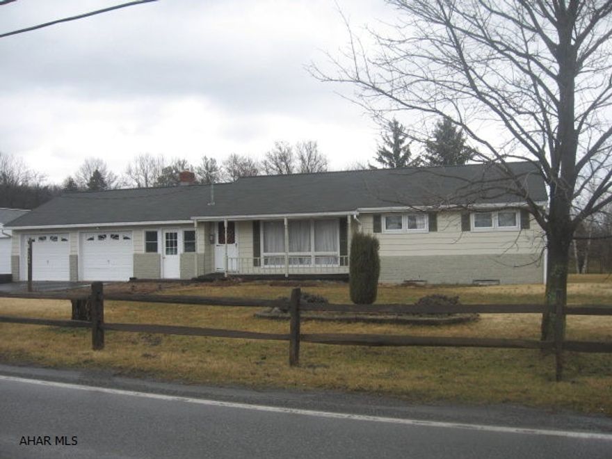 On one acre but close to town!  3 BR, 1 Bath, updated kitchen in 2000 with cherry cabinets and eat-in for 2. Dining area with a great back yard view - grass, mature trees, no neighbors.  10'x26' breezeway w/brick on part walls, propane stand-alone fireplace, big family room 31'x14' added for family get togethers. Covered front porch, split rail fence, edged flower beds - great country look!  This home needs some updating - flooring, front door area, shower unit - but can be a great family home on an acre of ground! Shed at back. Full basement unfinished with room to spread out or use as storage.  Two car garage that's 25' deep and has room for storage, too. Lots of room to spread out - inside and out!  Worth taking a look!