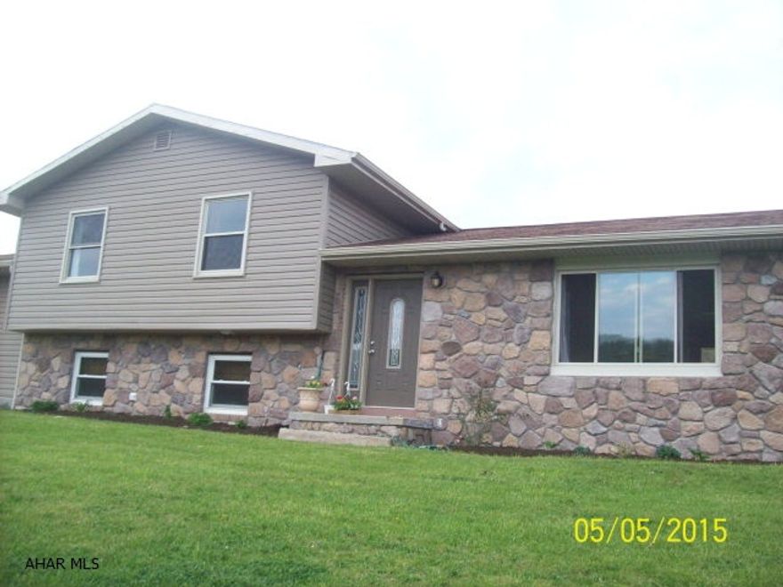 Motivated Sellers! Bring offers!!  Fabulous stone/vinyl multi-level home on 1.5 acre lot.  Main level has updated kitchen with removable island, dining room with sliding doors to outside patio, and living room.  Upper level has master bedroom with walk in closet and bathroom.  Also, 2 additional bedrooms and bath.  Lower level has 23X17 family room with beautiful stone fireplace.  Also, bath and laundry on this floor.  Huge basement plus 40X34 four car heated garage and workshop.  Fenced in yard for kids to play.  Lots to offer!!