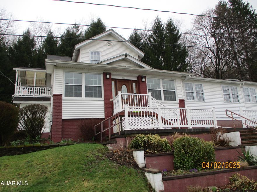 Very special and unique property in Tyrone Borough!   Perfect for the extended or growing family.  The original home has been updated and features a large living room,  kitchen  with island, lots of cabinets and bright, comfortable eating area.  The original front porch has been enclosed for additional sitting area, play room, etc.  First floor 1/2 bath, walk in pantry.  Second floor has a large owners suite with walk in closet, cozy second bedroom that opens to a covered deck, a third bedroom and large full bath. The home has been expanded with separate office and living quarters that features a great room, kitchenette with seating, appliances and full bath.  This section opens to a covered porch overlooking the dead end street and quiet green area included in the sale.  Two car integral garage with a third bay for storage or workshop.   At the rear of the property is a separate building which contains a sauna, hot tub and shower on the first floor.  The second floor features a great room and full bath.   The property has been equipped with holding tanks for rain water which can be used for irrigation.   Separate heating equipment for the original house, the addition and rear building.  Two level parcels of ground across 20th Street included in the sale.  Could be used for vegetable garden, fenced for outdoor game area, etc.