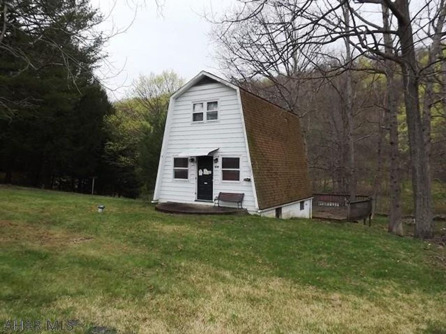 So much potential! A-Frame on an acre. Seasonal stream. In need of a complete rehab. Sold AS-IS.