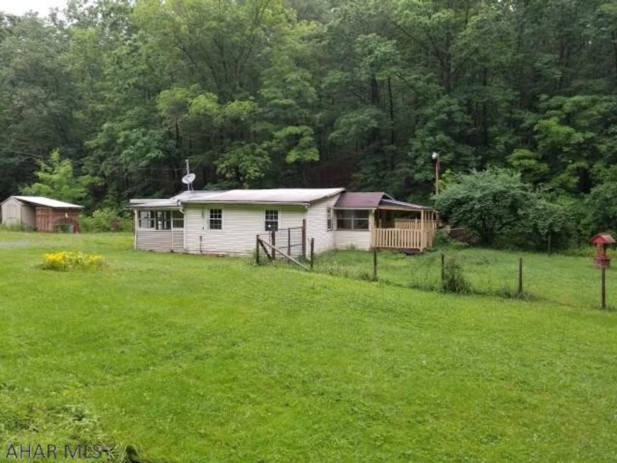 2 bedroom bungalow on 5.15 acres near Vail. Large deck over the stream. Large detached workshop.