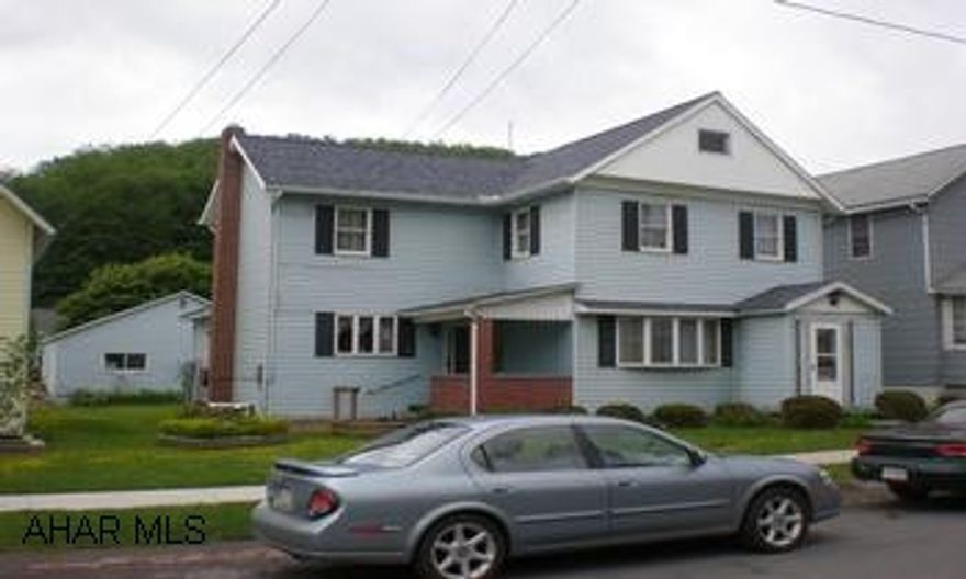 Large family home with detached garage and screened in picinic area.