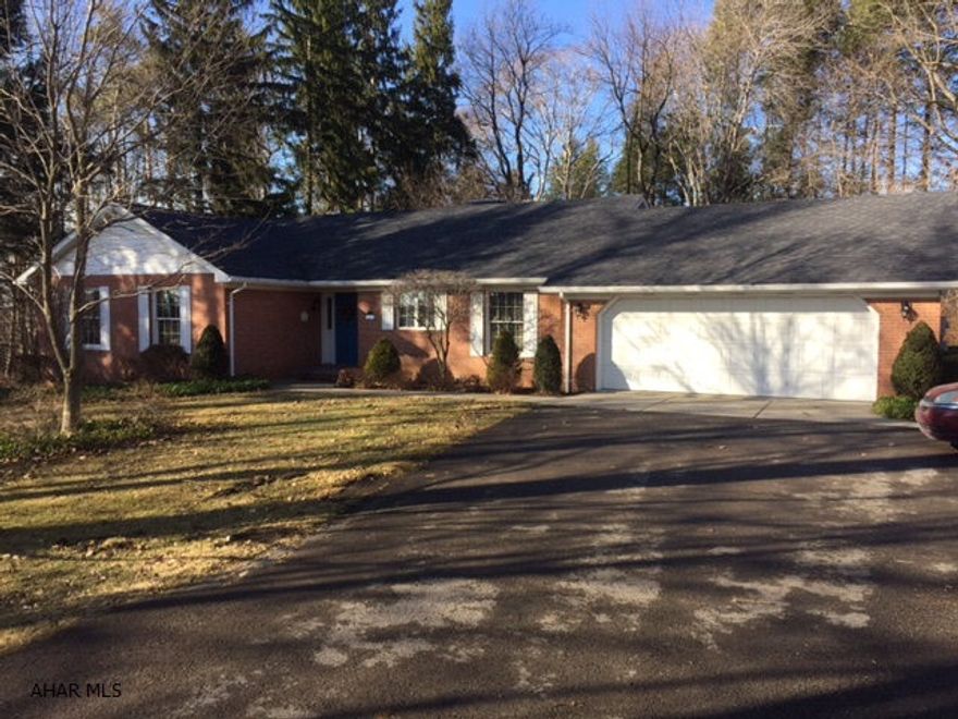 Gorgeous brick ranch on 1.5 acres in a country setting.This 3 bedroom 2 bath house has many amenities.. dining room w/wet bar, glass door, sun room w/wrap around deck. Partially finished large basement and 2 car garage all surrounded by outdoor beauty. Dont wait!