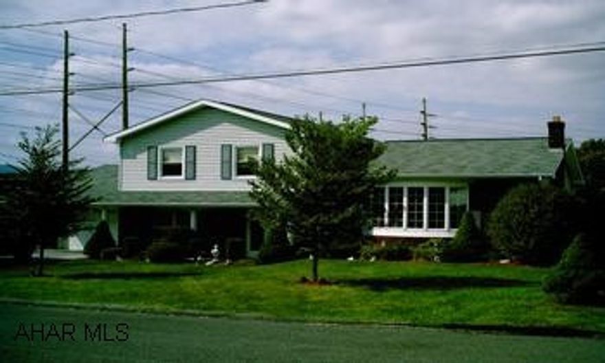 Beautiful split level home w/inground pool and patio overlooking pool.