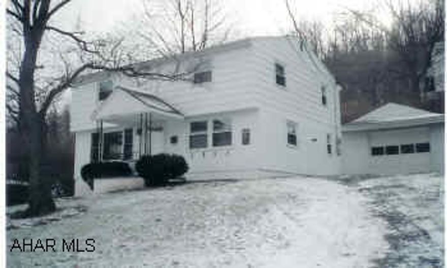 Cozy home, neutral carpeting, newer windows, corner fireplace, center-hall design. Sitting area (9x7) on second floor, pantry, updated bathrooms. Easy commute to town and recreation. Great starter home.