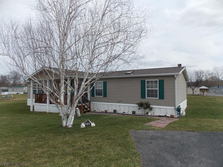 This lovely community, Independent Place is now a 55+ Community.  You will not believe how big this home is!  As you walk up to the house, the first thing you will notice is the inviting front porch. Step inside to the living room with the master bedroom and bath to the left.  Walking through the living room you see a formal dining room, eat in kitchen and the laundry room. Through the French Doos there is a  Family Room with a beautiful wood burning fireplace. The two guest rooms and full bath are off of the family room. Three Bedrooms with Master on one end and guest rooms on the other.  Three parking places for plenty of parking and a shed too.   This home is spotless and move in ready schedule your showing today. Lot rent $412 per month.