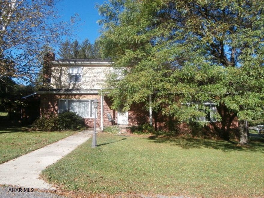 Brick two story with a one story addition. Large lot with 4 car detached garage. Great family home! Large family room with western walnut walls, Living room with fireplace and hardwood floor and chestnut walls, open kitchen, dining area, covered side patio. 5 lots.