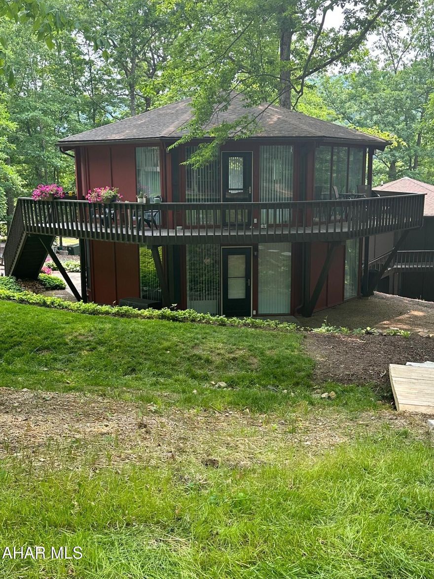 Looking for a place to escape too or permanent residence this unique, octagon home has all that! Features a unique conversation piece a spiral stairway,  large floor length windows in every room of the home. Open kitchen and living space, kitchen offers oak cabinetry with a pantry and island with a additional storage, master suite with a walk-in closet, private master bath and beautiful Bamboo flooring.  Spiraling down to the main floor is the second bedroom w/bathroom and  a bonus room that can be used a 3rd bedroom with an outside entry way.  Well maintained and lots of beautiful perennial's adding to the landscaping.  Nice wrap around porch over looking the Omni Bedford Springs Resort & Spa, Golf Course just within walking distance to enjoy the amenities of the Resort.  
Possibilities are endless, Air B & B, Retreat/vacation home,  walking trails adds convivence to the downtown shops and restaurant's!! There is room to add a garage or add on with the oversized lot.  Call for your tour today!