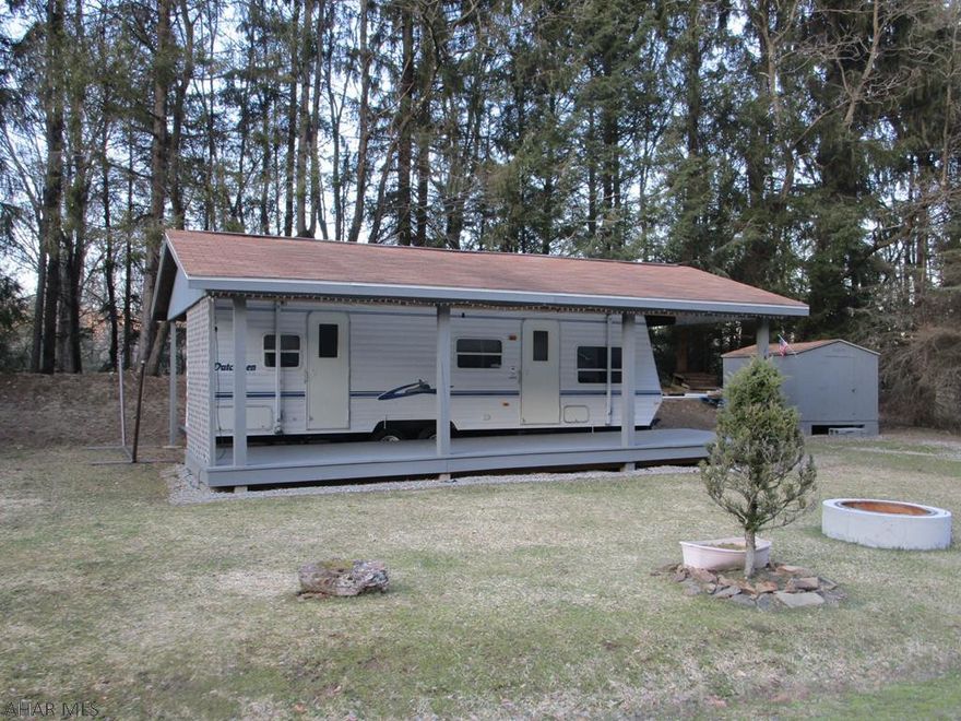 Cozy well maintained camper and deck covered by a pavilion.  Lot is flat and located on a dead end street.  Shed offers storage.  There is an air conditioner in the shed that goes on the top of the camper.