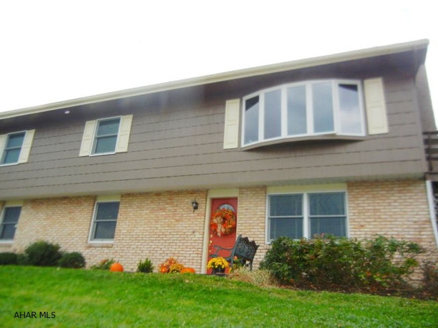 Stunning and spacious kitchen and actually very spacious throughout.  Prepare the meal in the custom built kitchen (fine line cabinets)  - you don't have to worry about space and cabinets! This owner thought of it all...Even the eating bar has more shelving underneath.  Then you can entertain on the large deck (with built in seating) while taking in the gorgeous view!!  On those chilly Winter evenings; you can simply light the gas fireplace and make memories with friends and family. The 2 car garage is heated and has AC.  Home is situated on almost 1/2 acre of ground (with invisible fence already installed) ALSO, HOME WARRANTY..  Great home to raise your family.  Call agent today to schedule your own private showing.  ONLY $195,000
