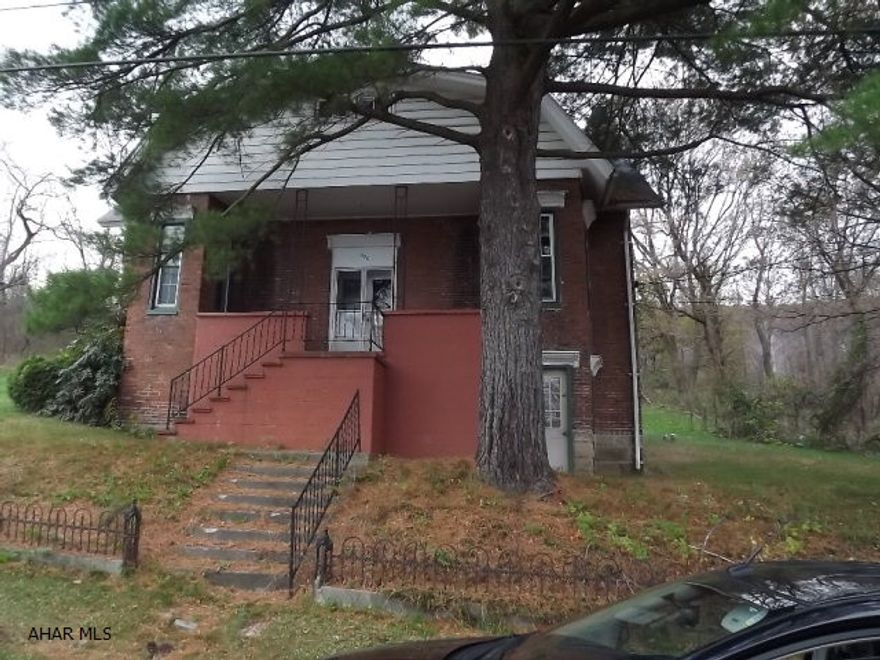 Bring your ideas to this once charming, brick, 2-story. Almost 1/2 acre lot. Replacement windows.