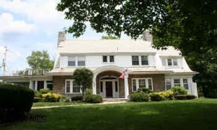 Prestigious 2-story classic Dutch Colonial stone/vinyl home located on corner lot in Bedford. Side circular drive & portico white pillars enhance the elegant front entry. Screened Lanai, stone patio, professional landscaping. High ceilings, crown molding, leaded glass, chandeliers, oak woodwork, original millwork & built-ins. Pegged oak flooring, ceramic tile, carpet. 2-car detached and 1-car integral