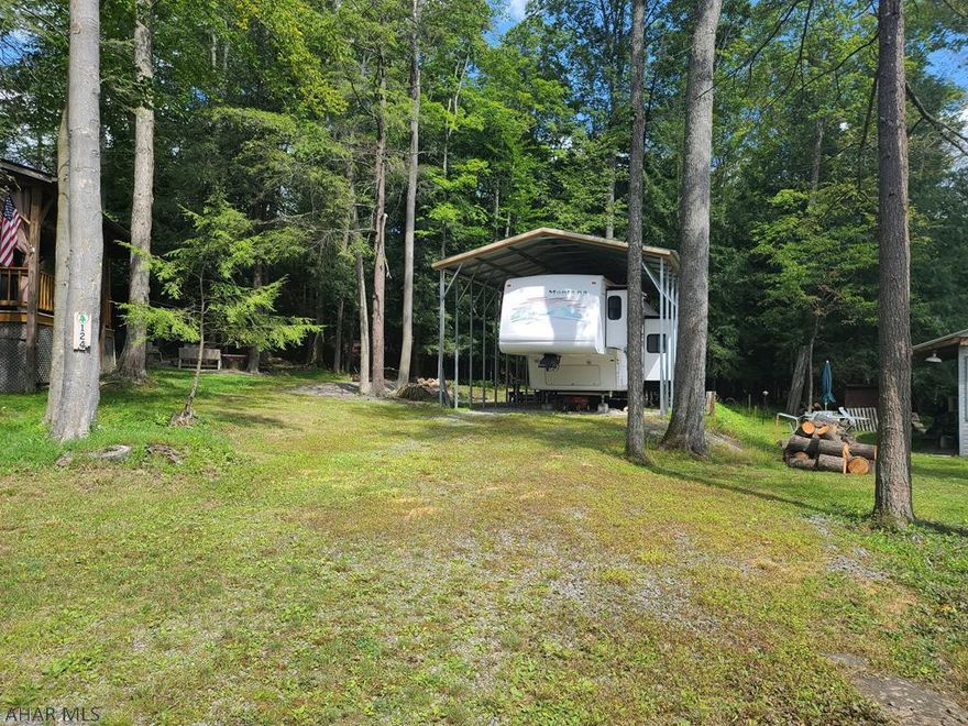 30' 5th wheel 2002 camper under a metal frame pavillion on 1 lot inside Glendale Yearound. Camper is very roomy and in great condition. There is a washing machine included. Glendale Yearound is a gated community located minutes from Glendale Lake and Prince Gallitzin State Park. Community pool, basketball, tennis, security, and more.