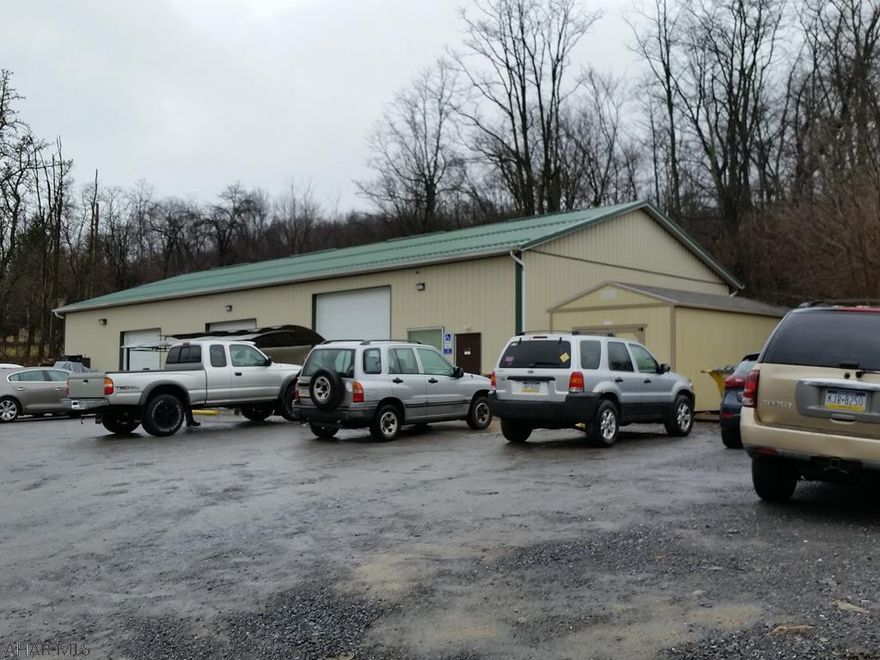 Great Business Location!  40x80' warehouse/showroom space w/2 offices, 1/2 bath, 3 oversized overhead doors + detached shed on 1/2 acre.  J-428